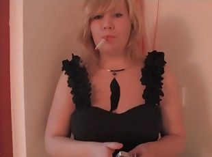 Curvy blonde in a black dress smokes