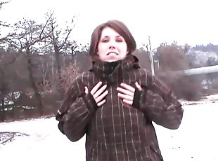 Short haired brunette in jeans fondles her nice tits outdoors