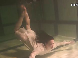 Vintage shoot of solo model brunette swimming seductively