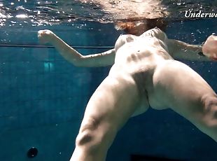 Sexy bombshell gets into the pool completely naked