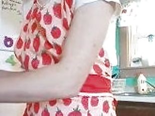 Young MILF cooks pasta sauce in a little outfit