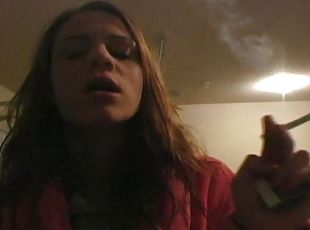 Teenager in bathrobe smokes sensually