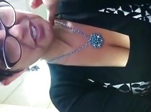 Brunette milf in glasses shows her sexy cleavage for the webcam