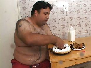 Fat guy with small cock eats a cake and gets a blowjob