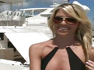 Two sizzling blonde girls toy their pussies on a yacht
