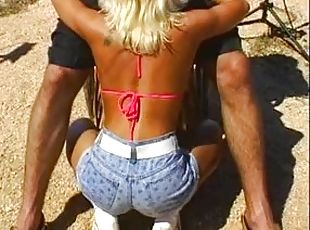 Hot blonde sucking a big hard cock on the beach