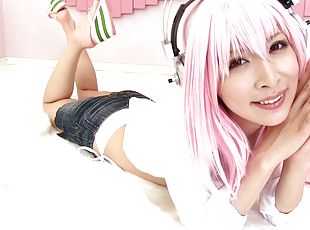 A pink haired Japanese babe in a bikini gets jizzed on