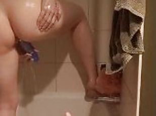 Young MILF pleasures herself in shower