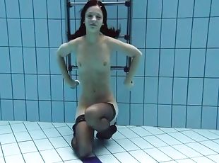 Slim swimming girl in black stockings