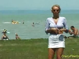 Crazy pee girl on the beach