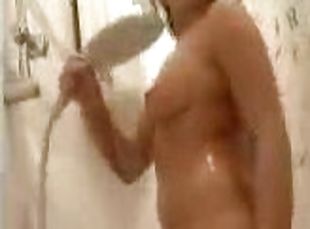Horny brunette masturbates her pussy while taking a shower