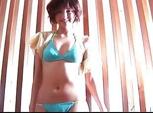 Skinny young chick in a blue bikini solo