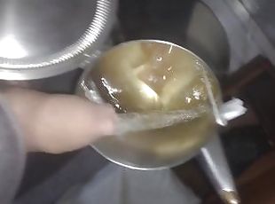 Boy pissing in a tea refill