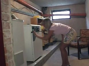 Pierced blonde gives a nice hand job in the basement