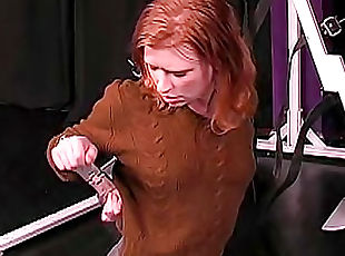 Redhead in sweater bound in dungeon